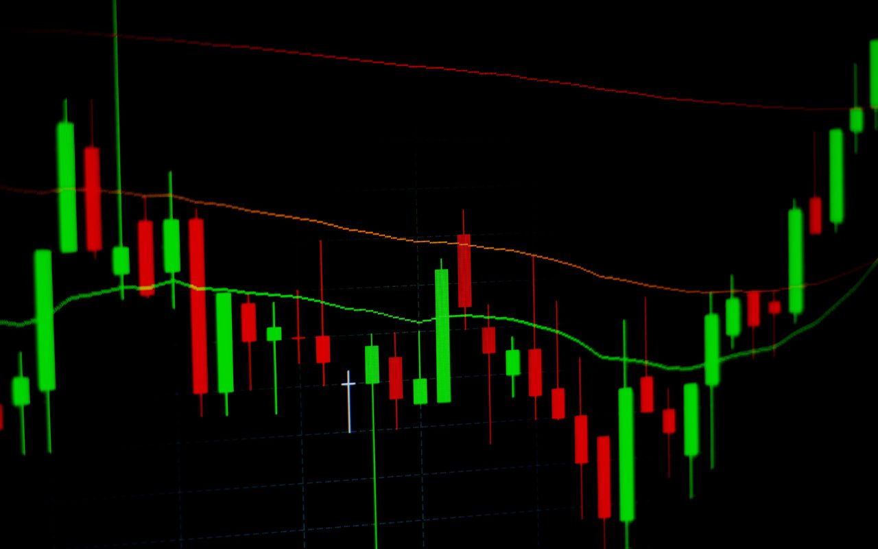 Colourful candlestick chart on a black background, illustrating market trends and fluctuations commonly seen in forex trading analysis.